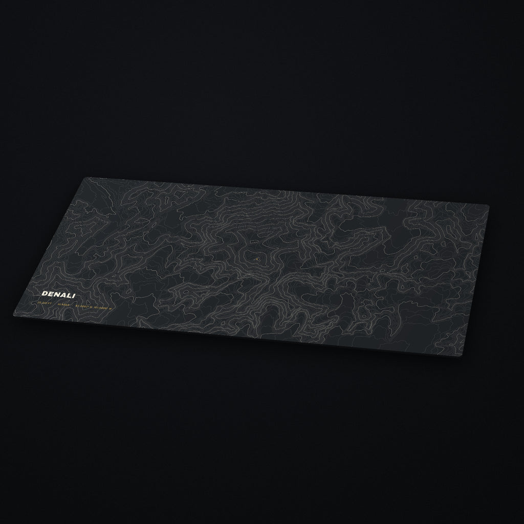 Denali Topo Desk Mat at an angle on a dark desk