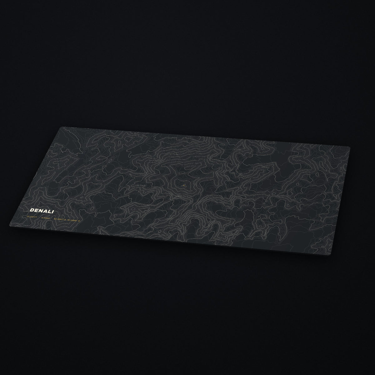Denali Topo Desk Mat at an angle on a dark desk