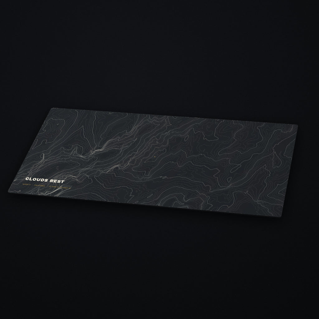 Clouds Rest Topo Desk Mat at an angle on a dark desk