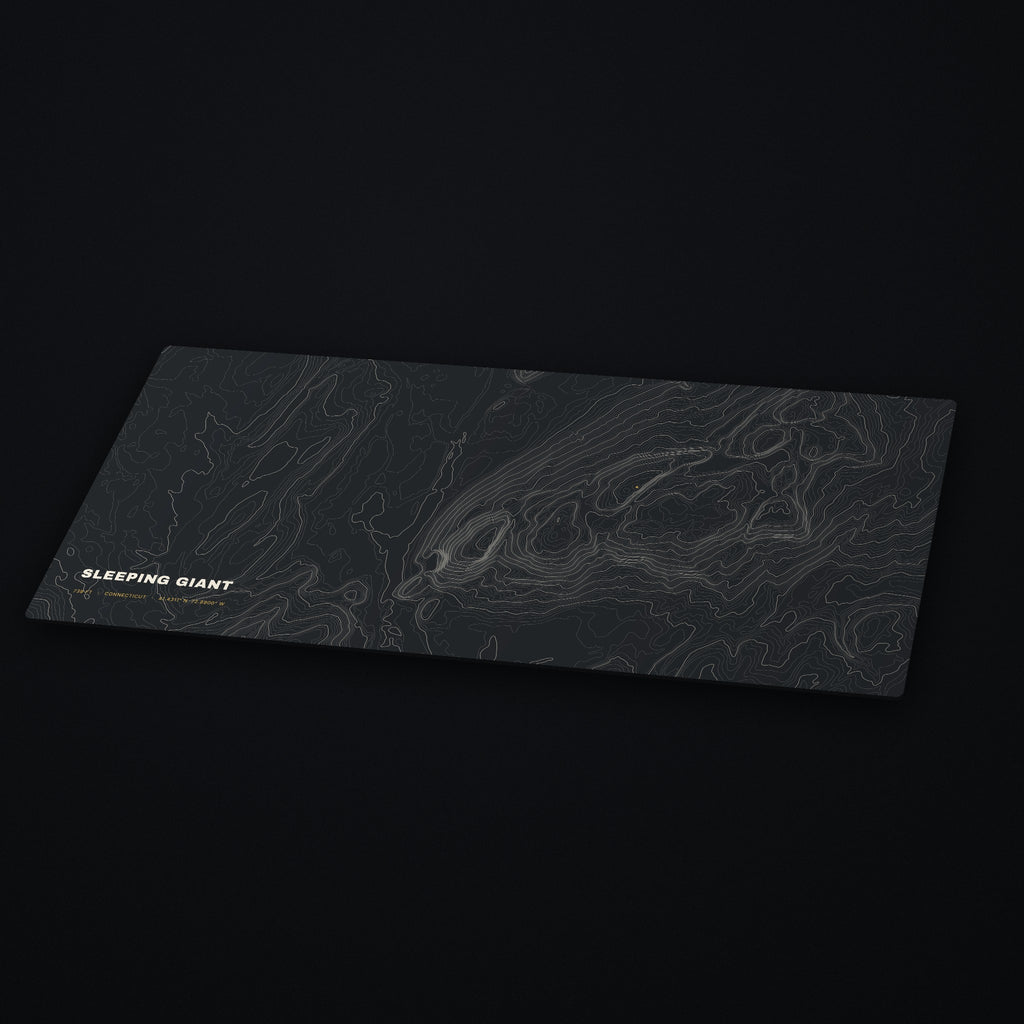 Sleeping Giant Topo Desk Mat at an angle on a dark desk