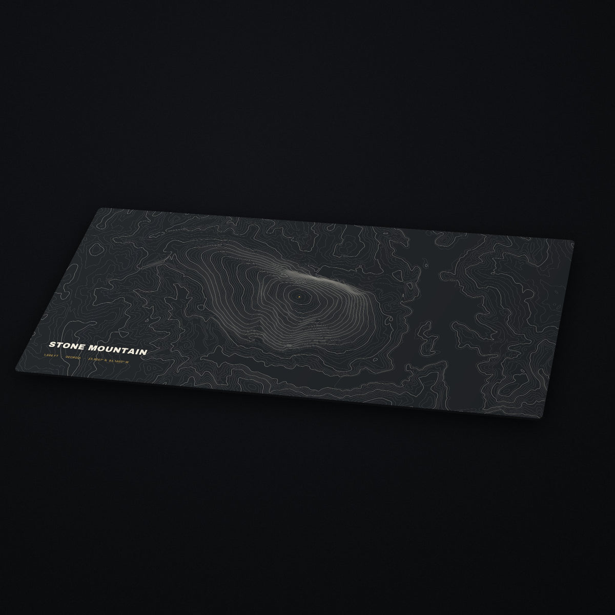 Stone Mountain Topo Desk Mat at an angle on a dark desk