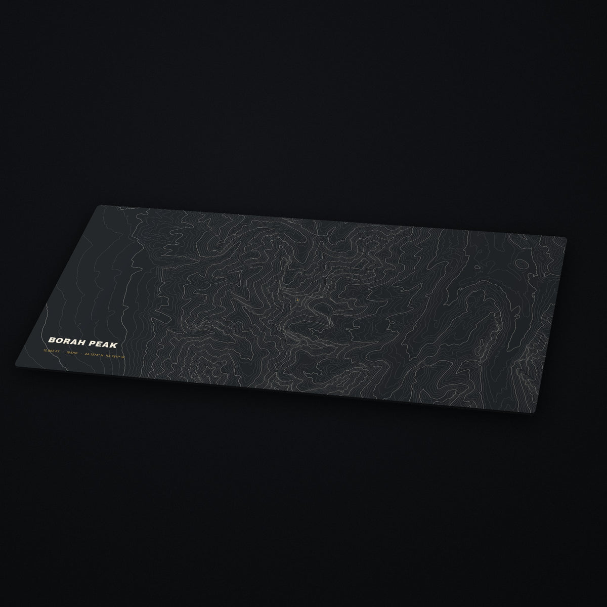 Borah Peak Topo Desk Mat at an angle on a dark desk