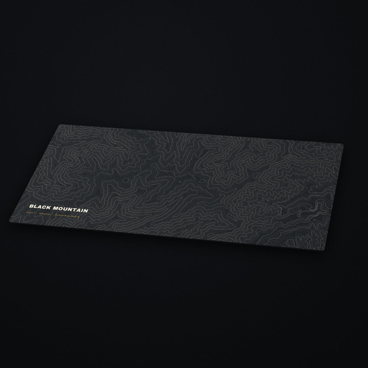 Black Mountain Topo Desk Mat at an angle on a dark desk