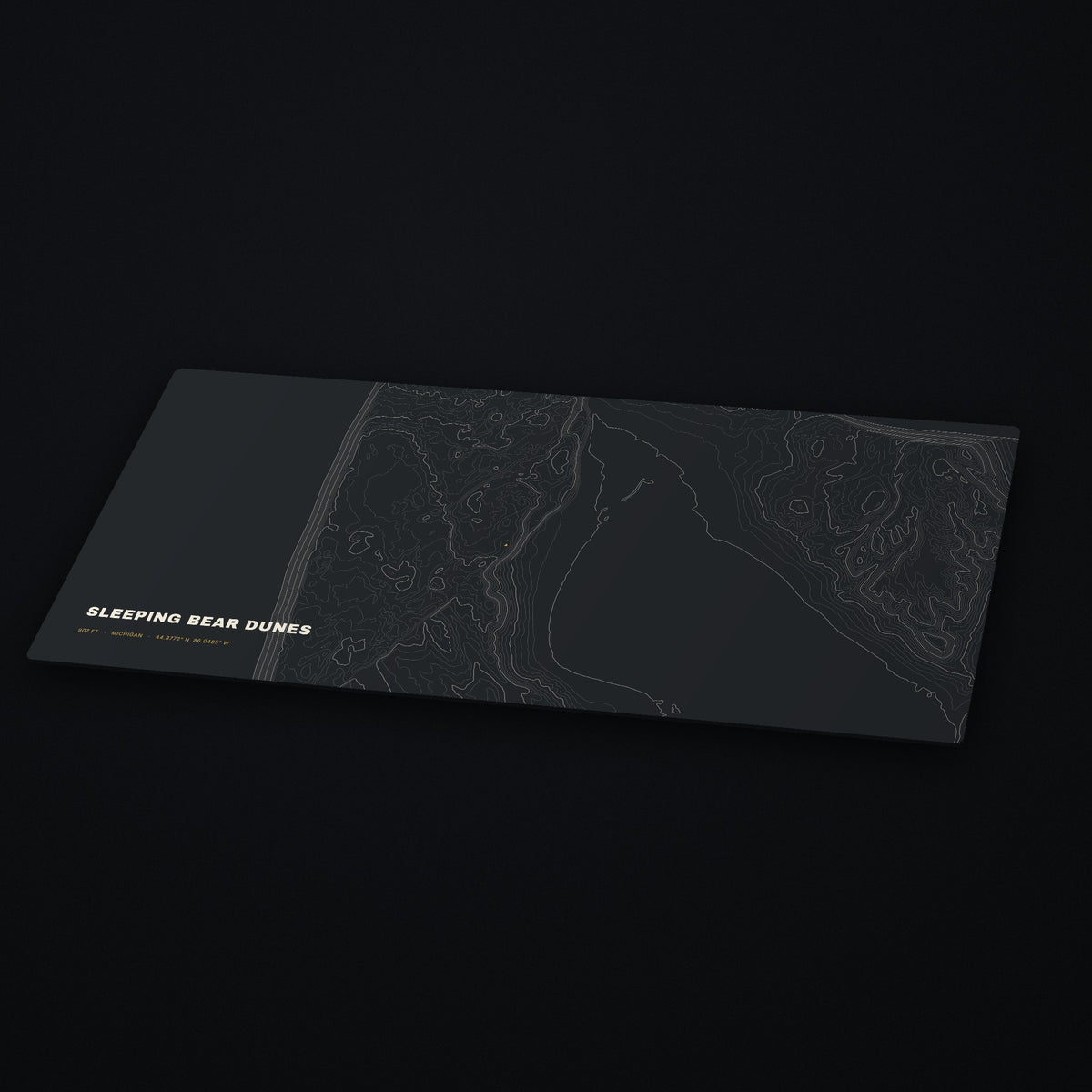 Sleeping Bear Dunes Topo Desk Mat at an angle on a dark desk