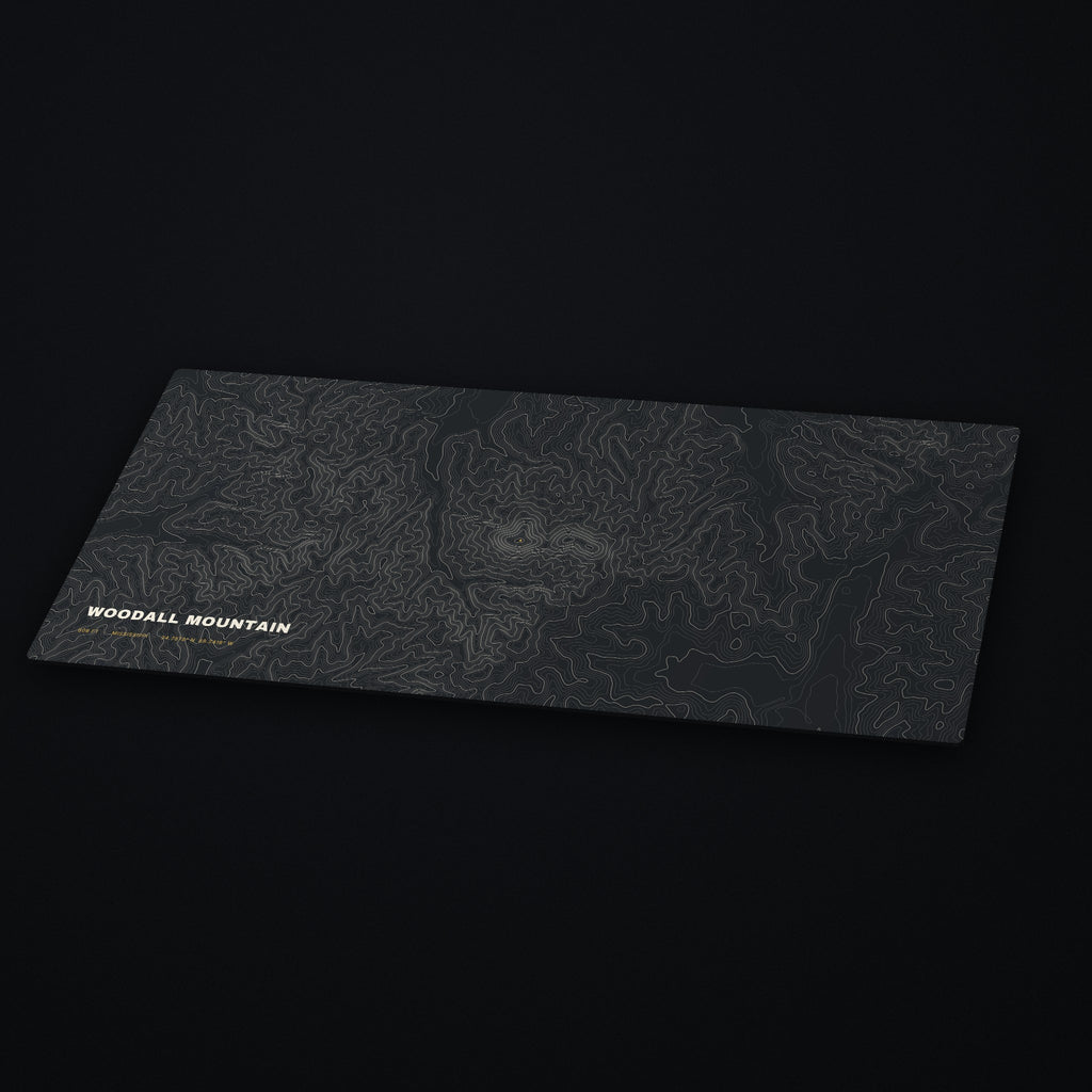 Woodall Mountain Topo Desk Mat at an angle on a dark desk