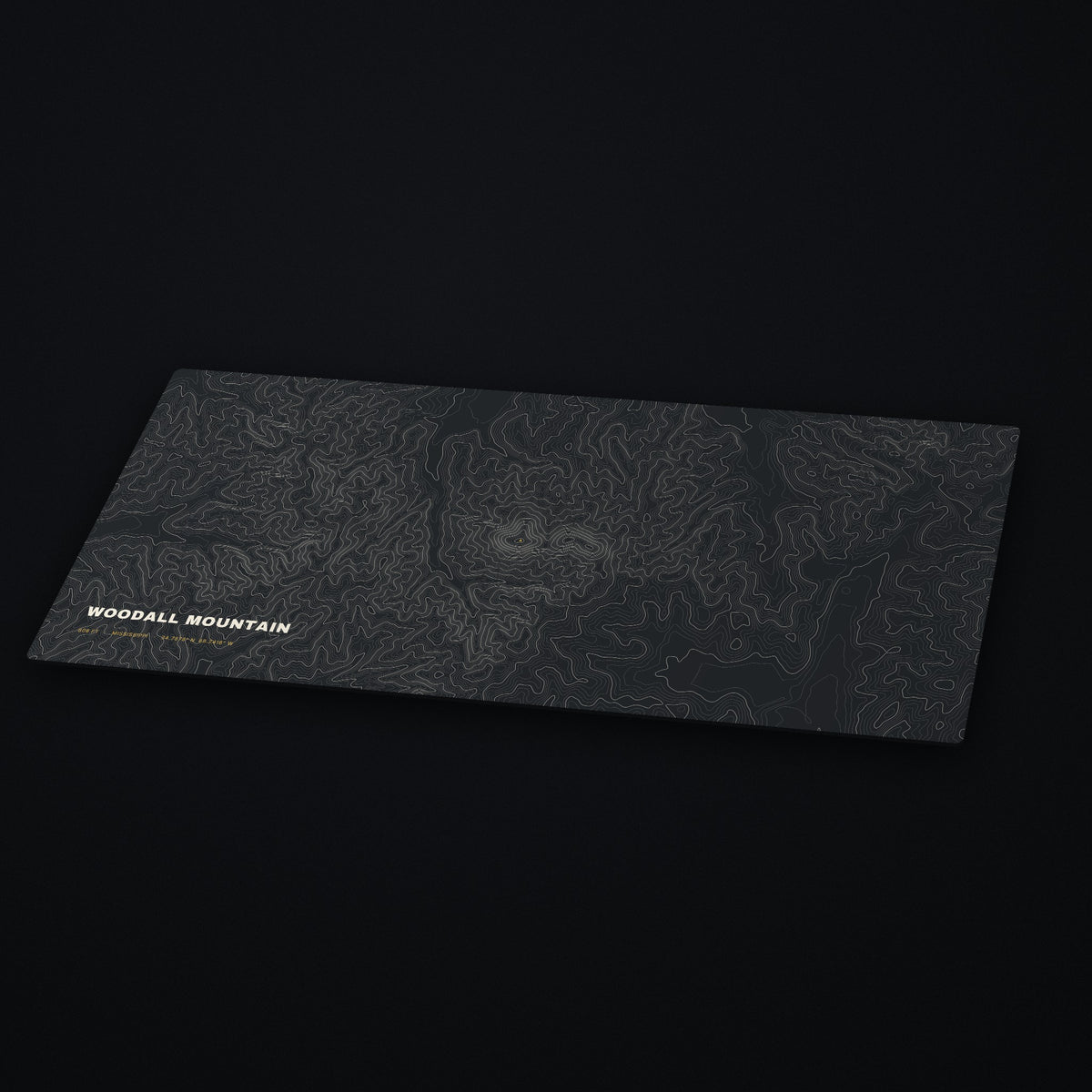 Woodall Mountain Topo Desk Mat at an angle on a dark desk