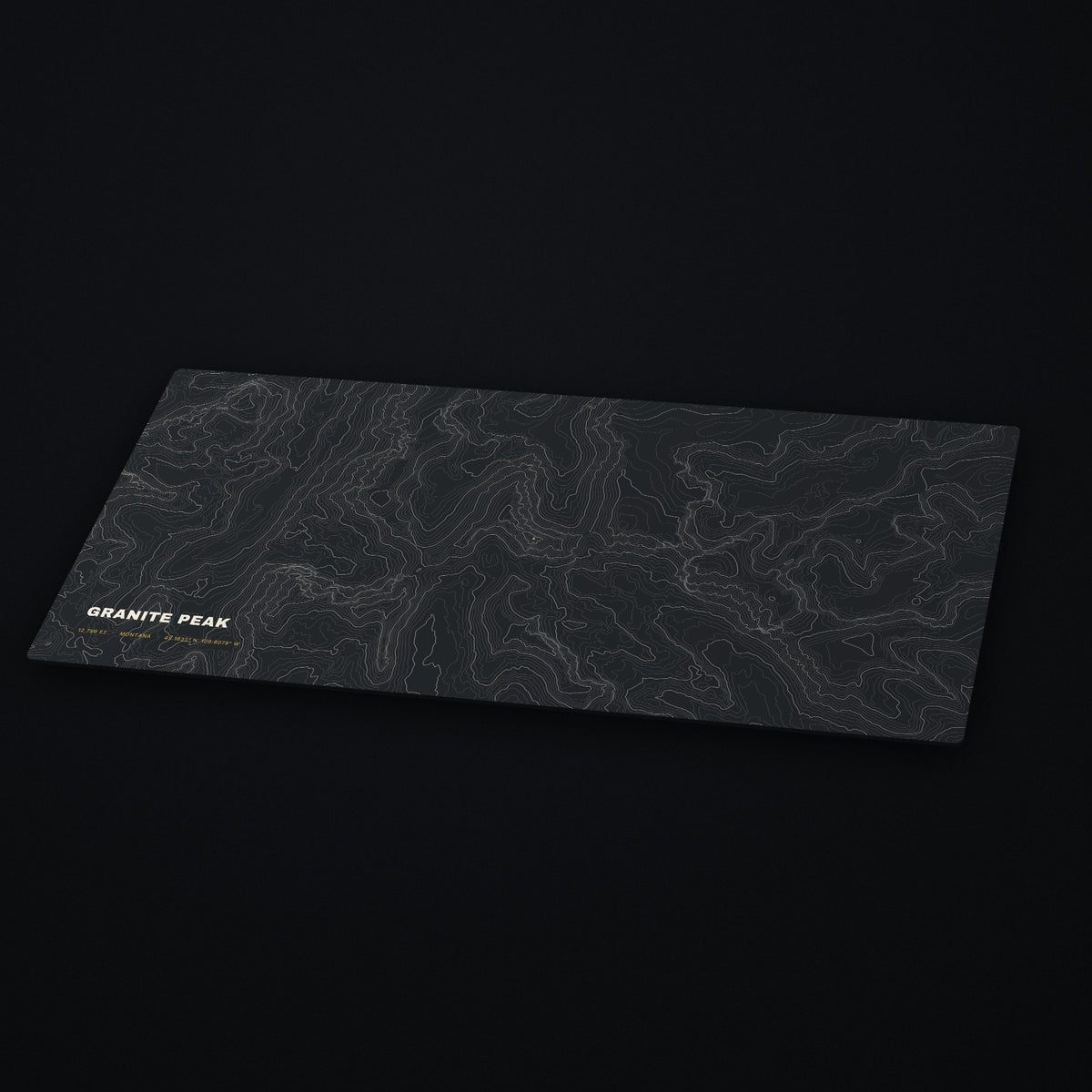 Granite Peak Topo Desk Mat at an angle on a dark desk