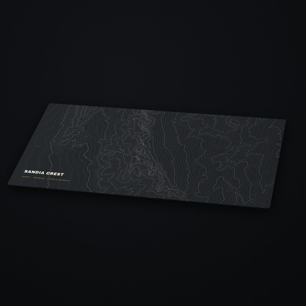 Sandia Crest Topo Desk Mat at an angle on a dark desk