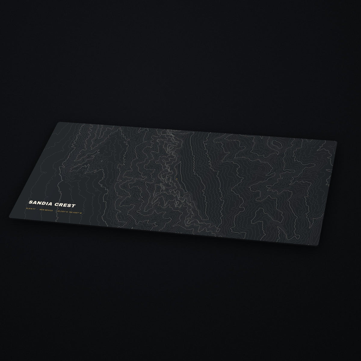 Sandia Crest Topo Desk Mat at an angle on a dark desk