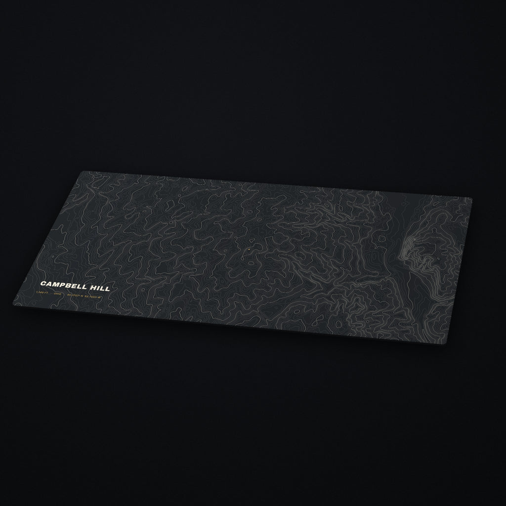 Campbell Hill Topo Desk Mat at an angle on a dark desk