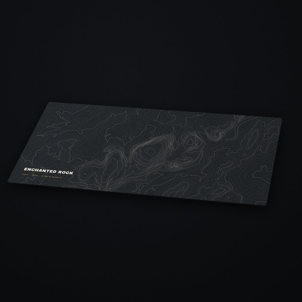 Enchanted Rock Topo Desk Mat at an angle on a dark desk
