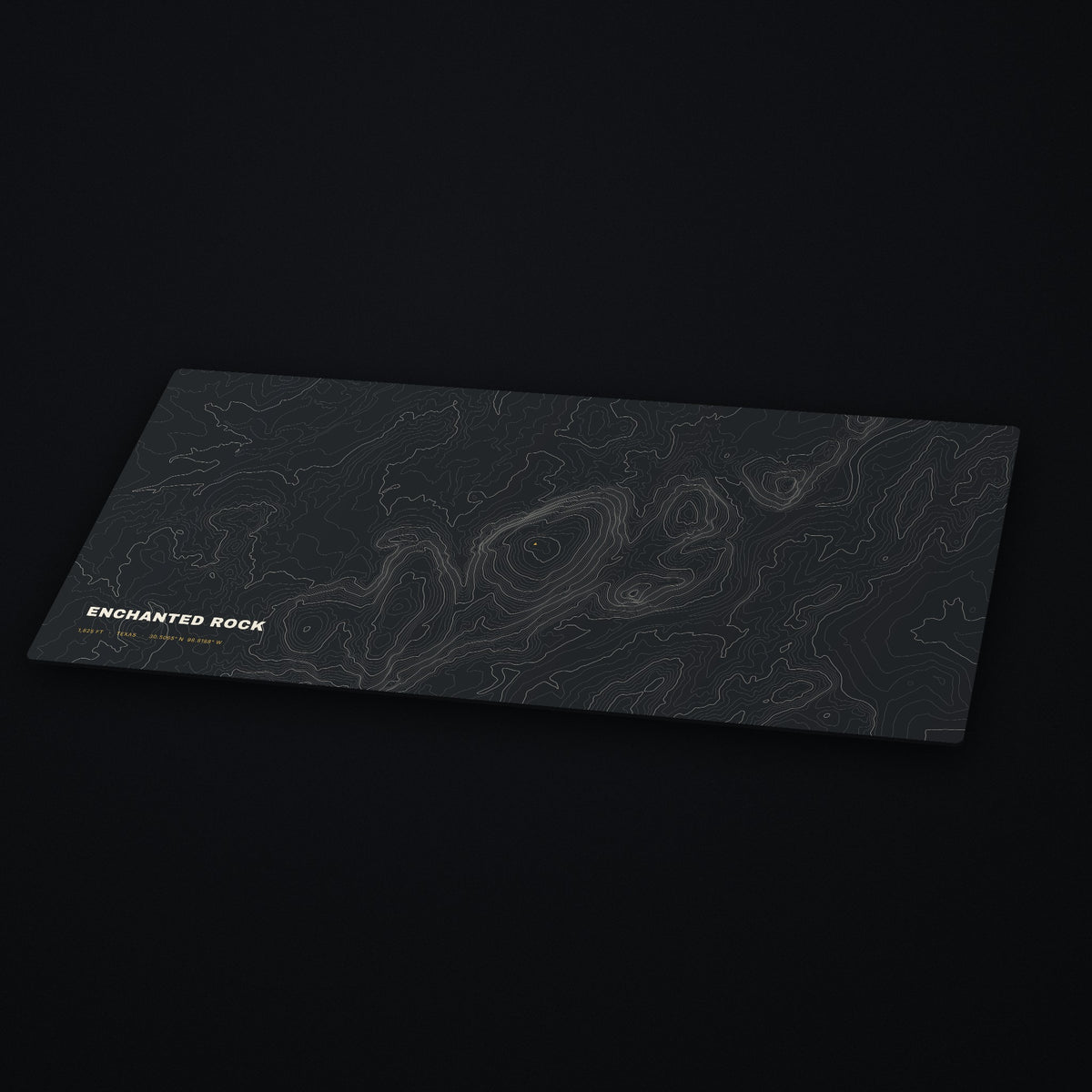 Enchanted Rock Topo Desk Mat at an angle on a dark desk