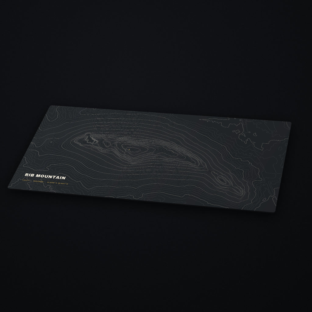 Rib Mountain Topo Desk Mat at an angle on a dark desk