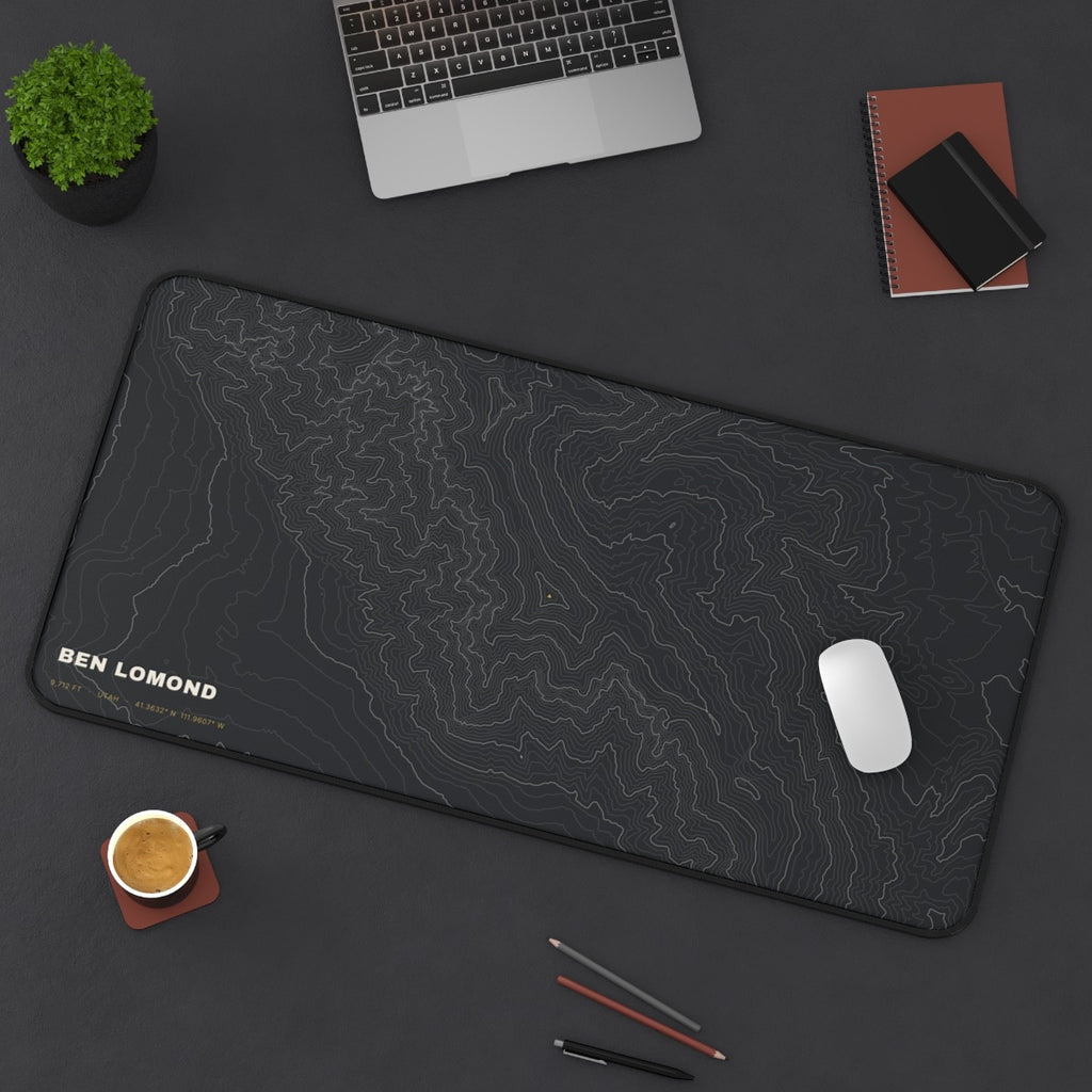Ben Lomond Topo desk mat on a desk with a laptop, mouse and coffee cup for scale
