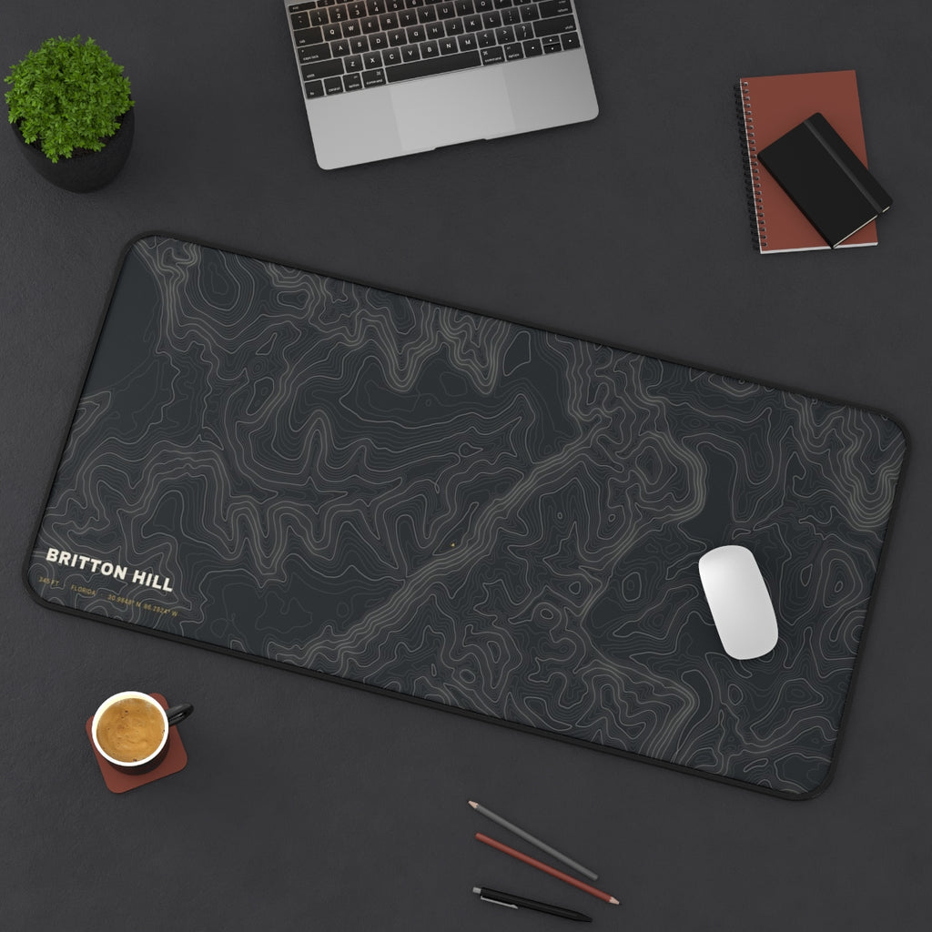 Britton Hill Topo desk mat on a desk with a laptop, mouse and coffee cup for scale