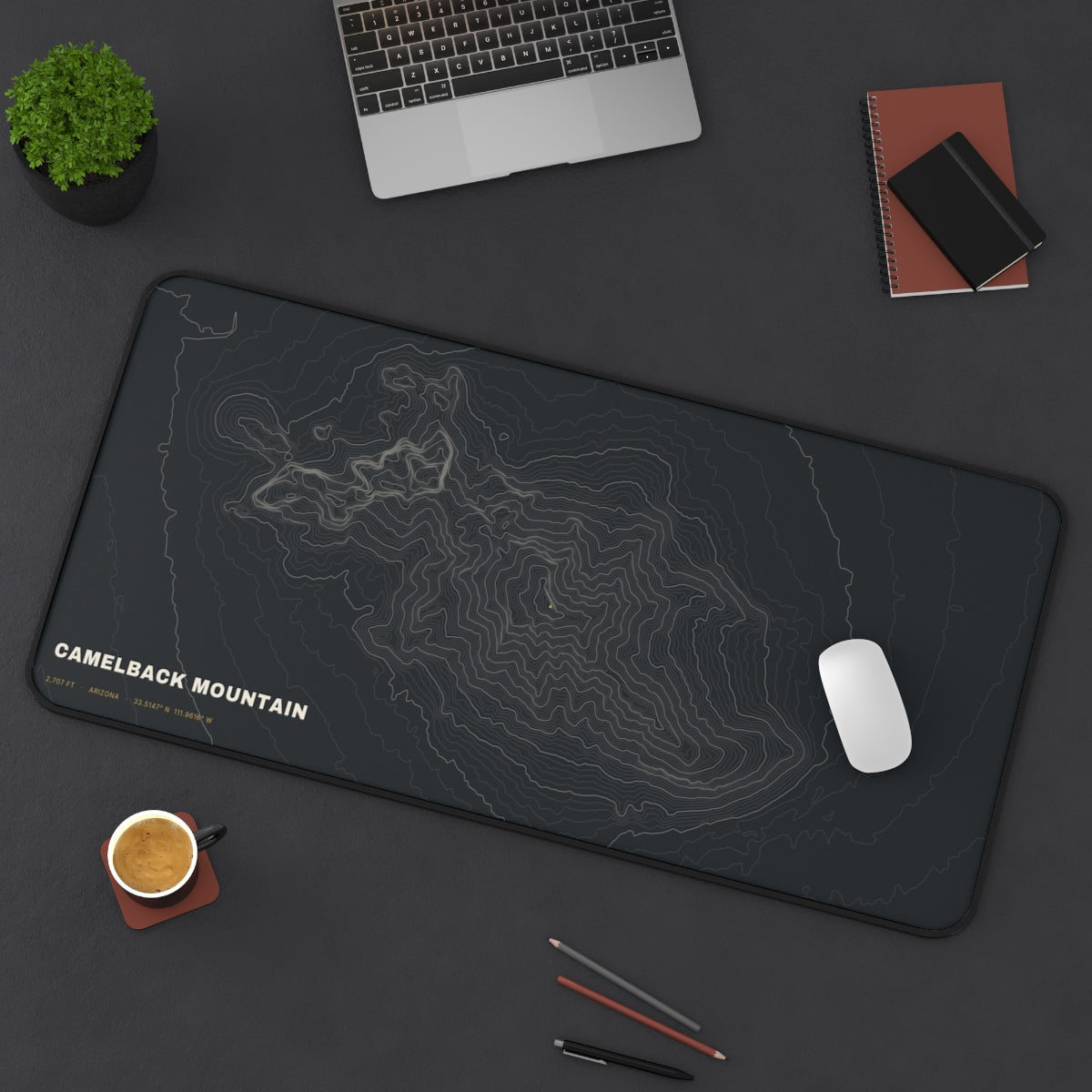 Camelback Mountain Topo desk mat on a desk with a laptop, mouse and coffee cup for scale