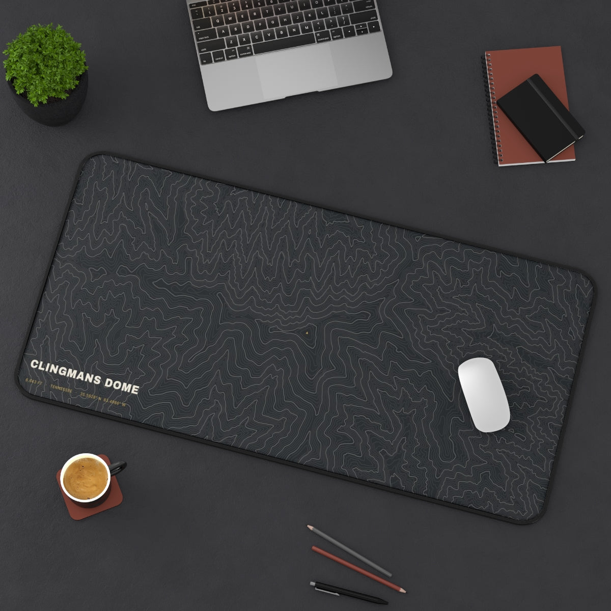 Clingmans Dome Topo desk mat on a desk with a laptop, mouse and coffee cup for scale