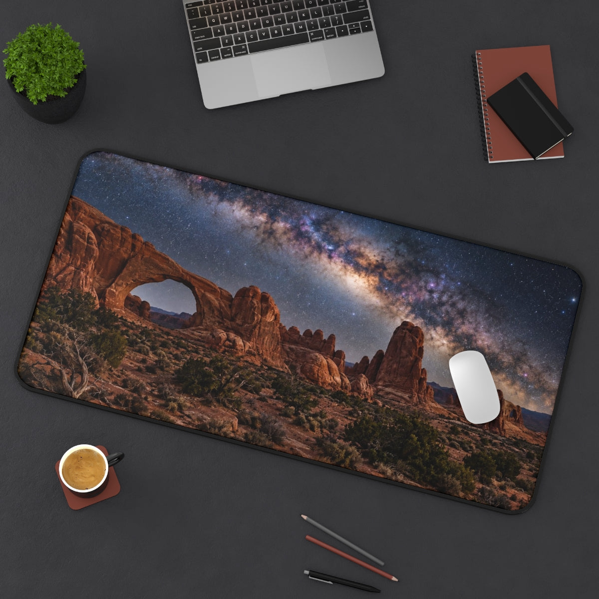 Desert Milky Way desk mat on a desk with a laptop, mouse and coffee cup for scale