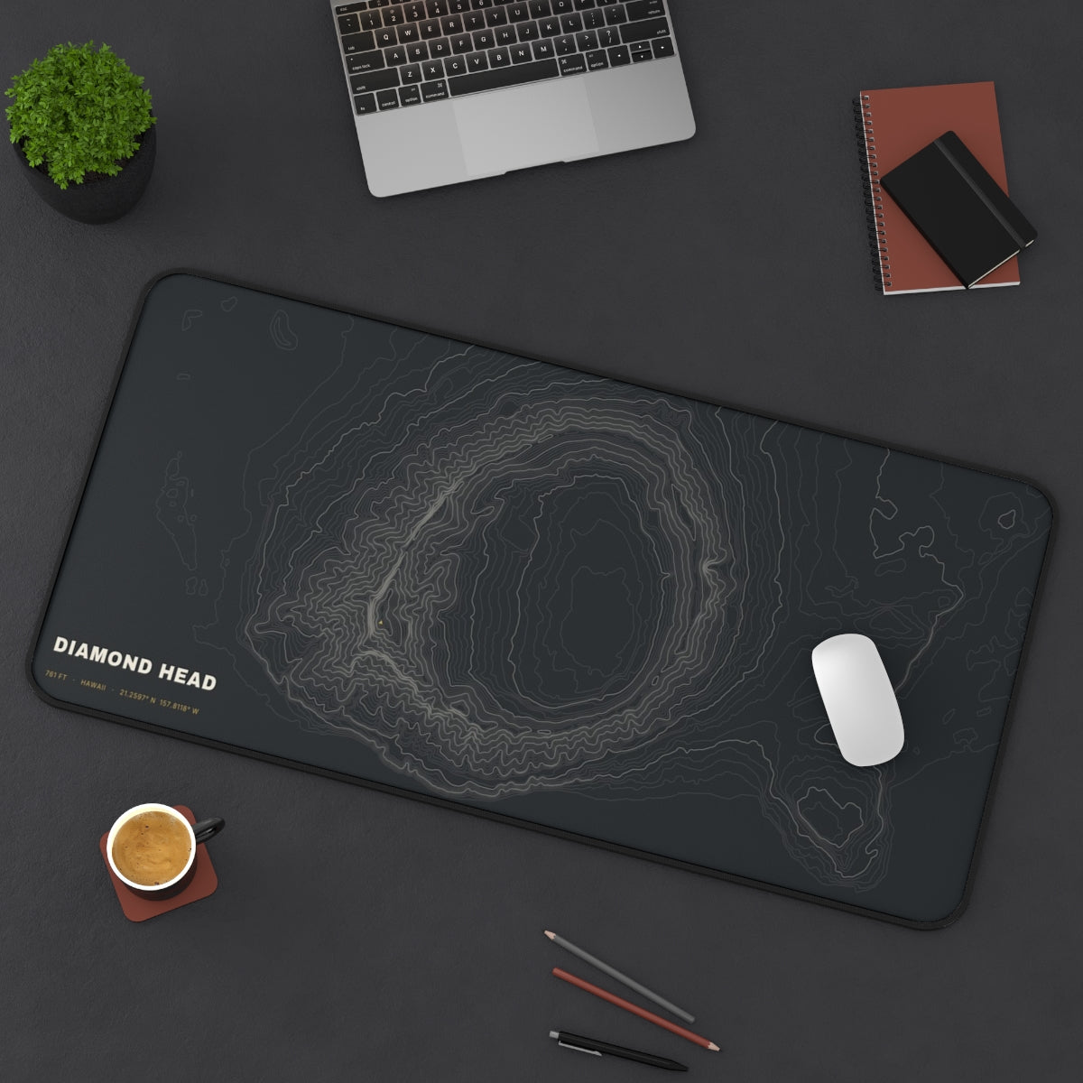 Diamond Head Topo desk mat on a desk with a laptop, mouse and coffee cup for scale