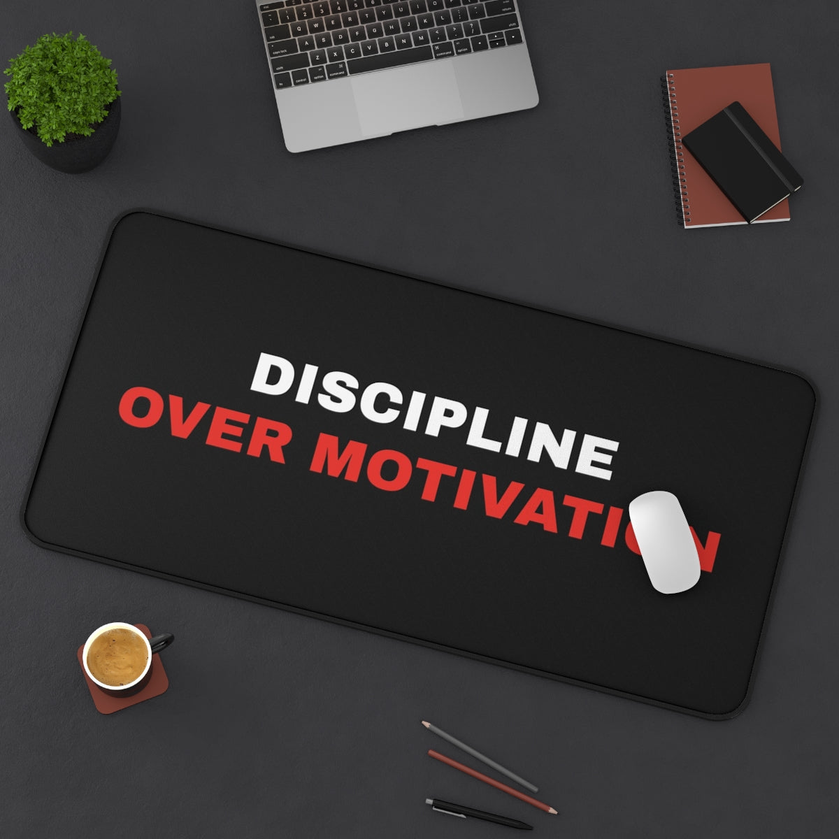 Discipline Over Motivation desk mat on a desk with a laptop, mouse and coffee cup for scale