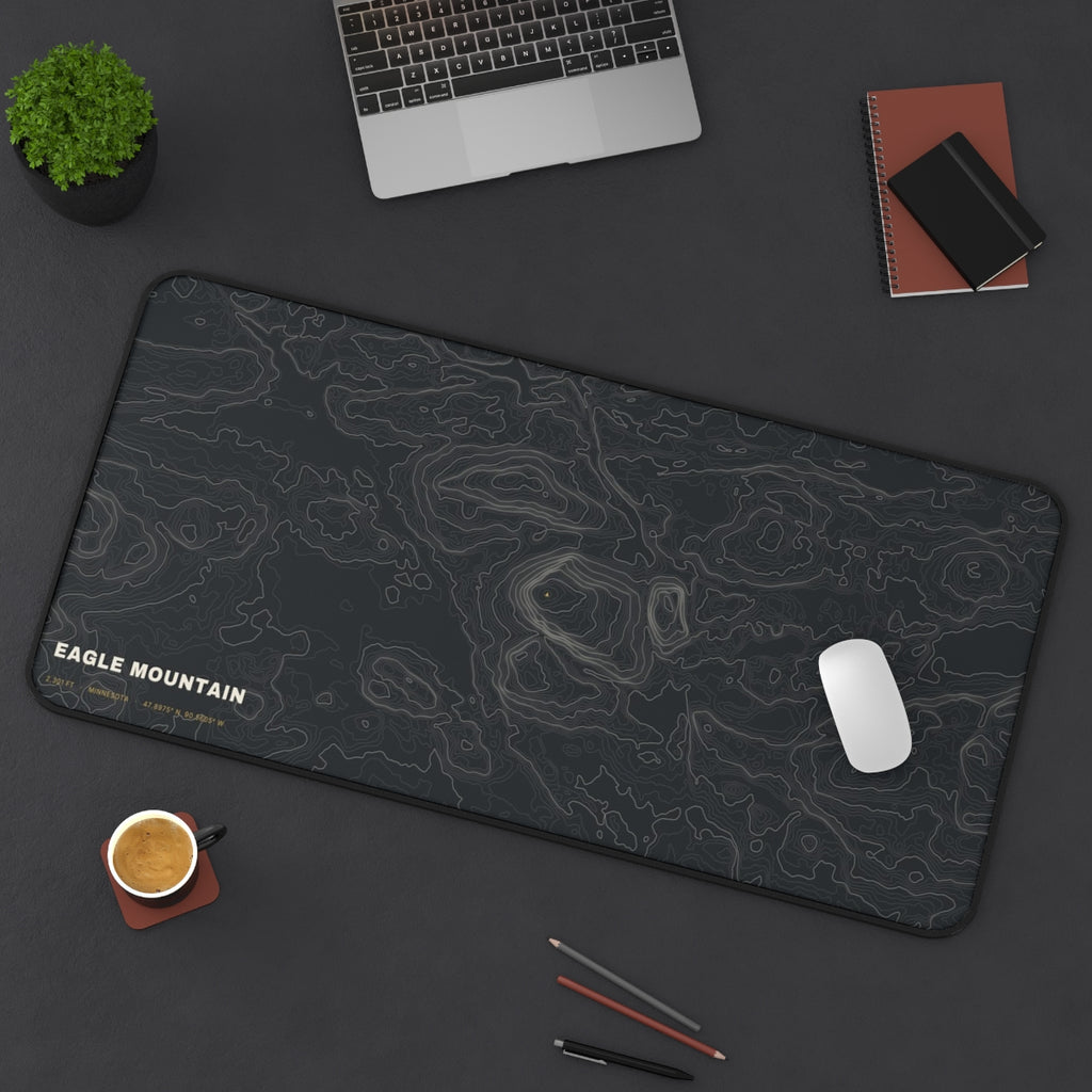 Eagle Mountain Topo desk mat on a desk with a laptop, mouse and coffee cup for scale