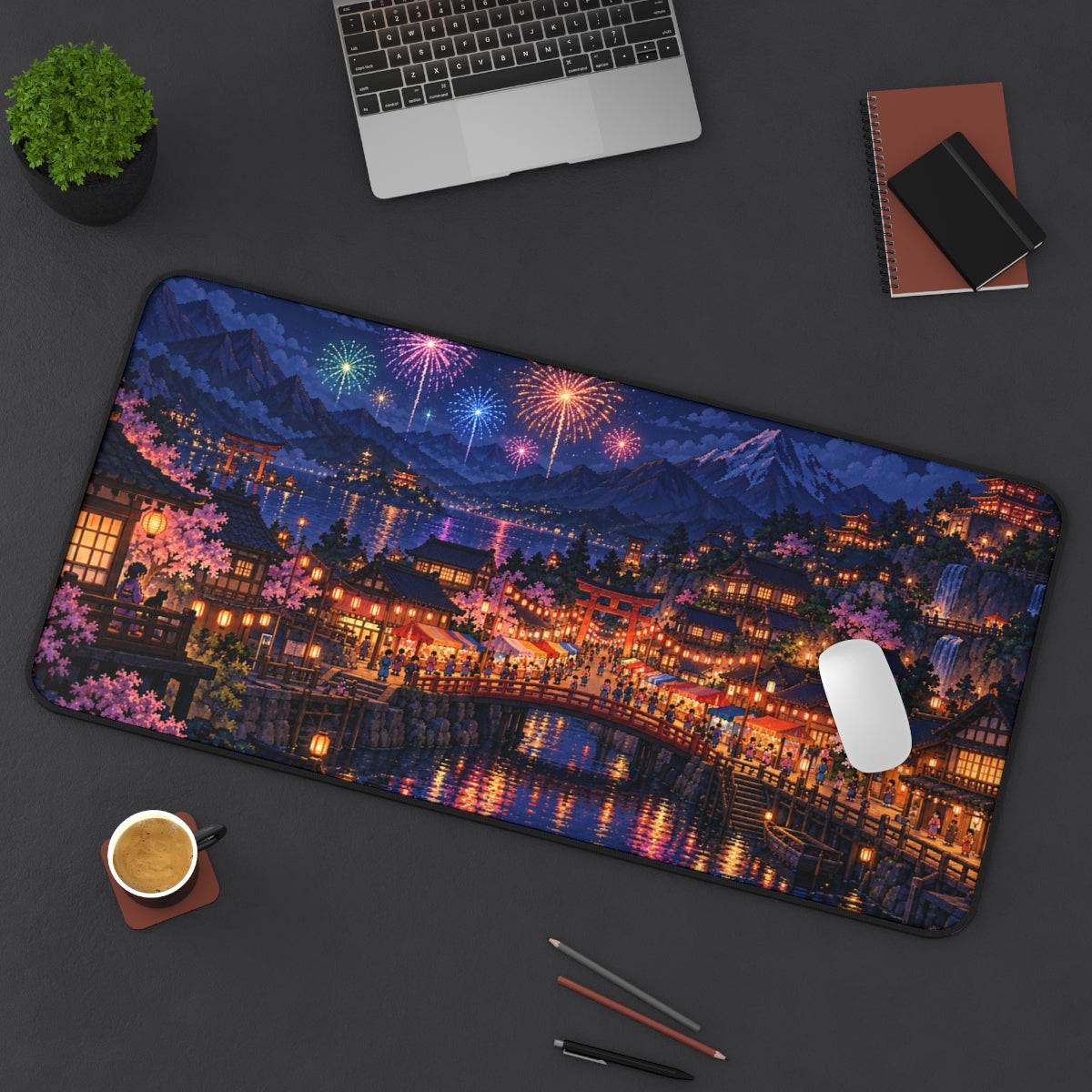 Festival Town desk mat on a desk with a laptop, mouse and coffee cup for scale