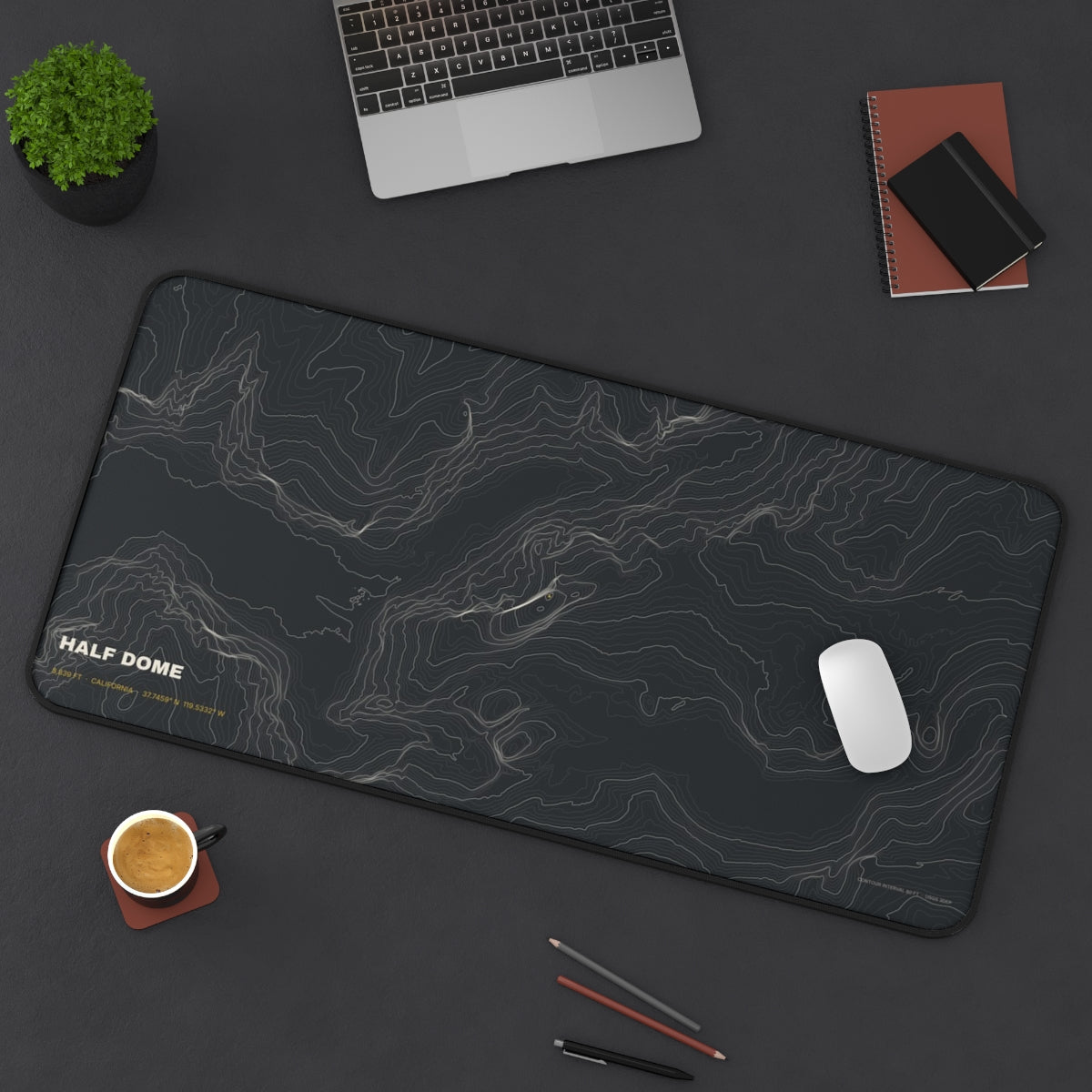 Half Dome Topo desk mat on a desk with a laptop, mouse and coffee cup for scale