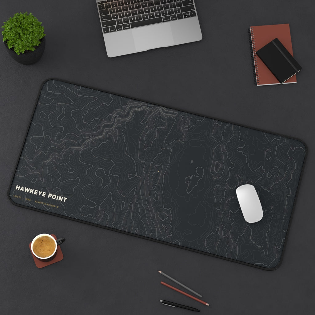Hawkeye Point Topo desk mat on a desk with a laptop, mouse and coffee cup for scale