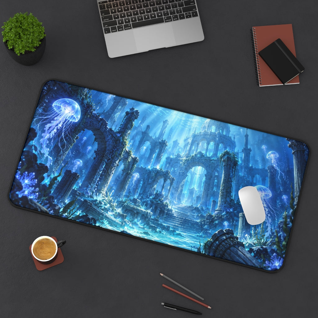 Jellyfish Ruins desk mat on a desk with a laptop, mouse and coffee cup for scale
