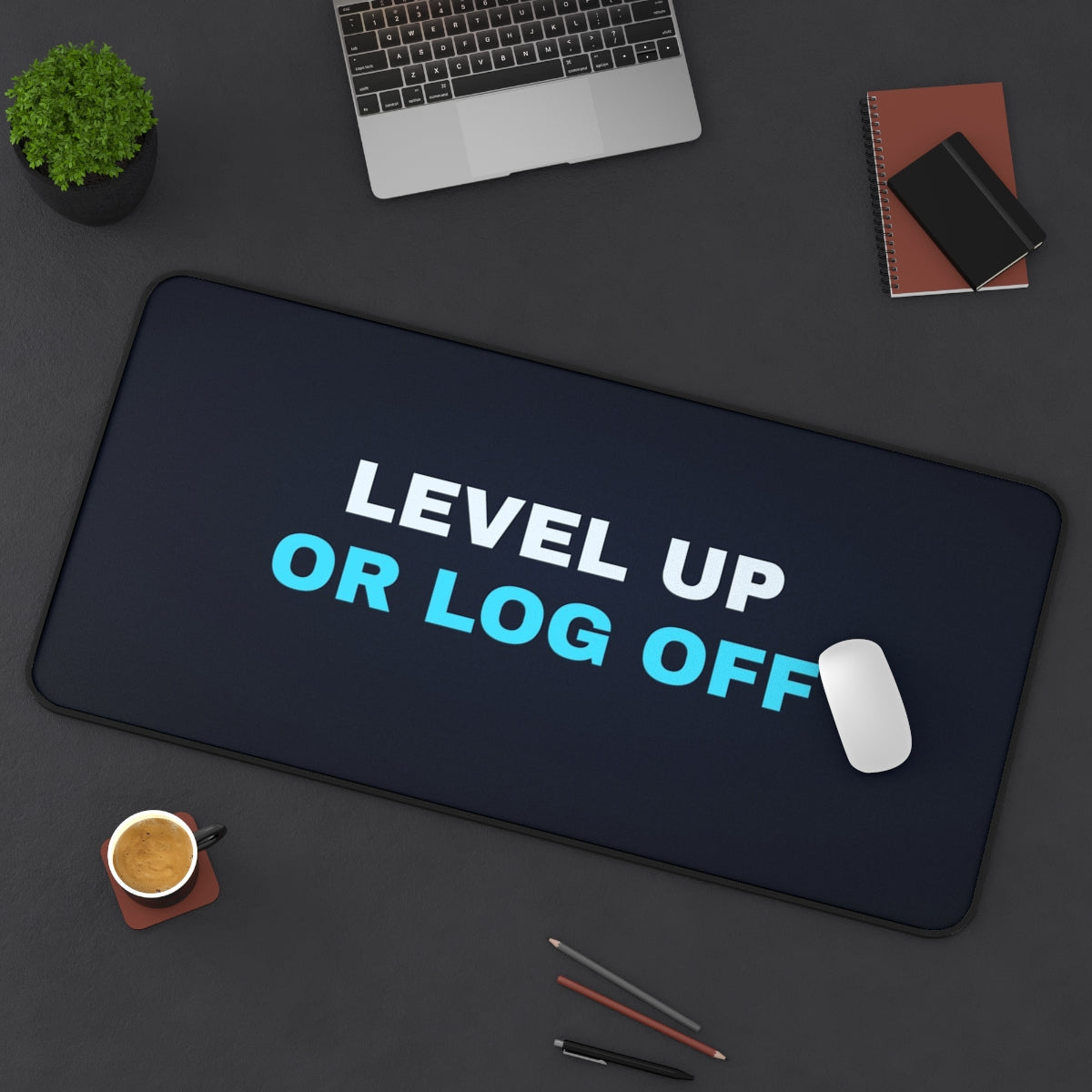 Level Up or Log Off desk mat on a desk with a laptop, mouse and coffee cup for scale