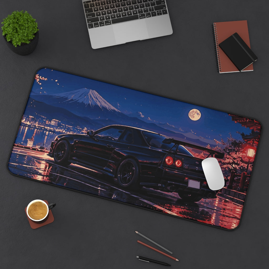 Midnight Overlook desk mat on a desk with a laptop, mouse and coffee cup for scale