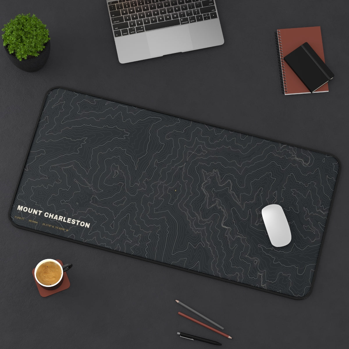 Mount Charleston Topo desk mat on a desk with a laptop, mouse and coffee cup for scale