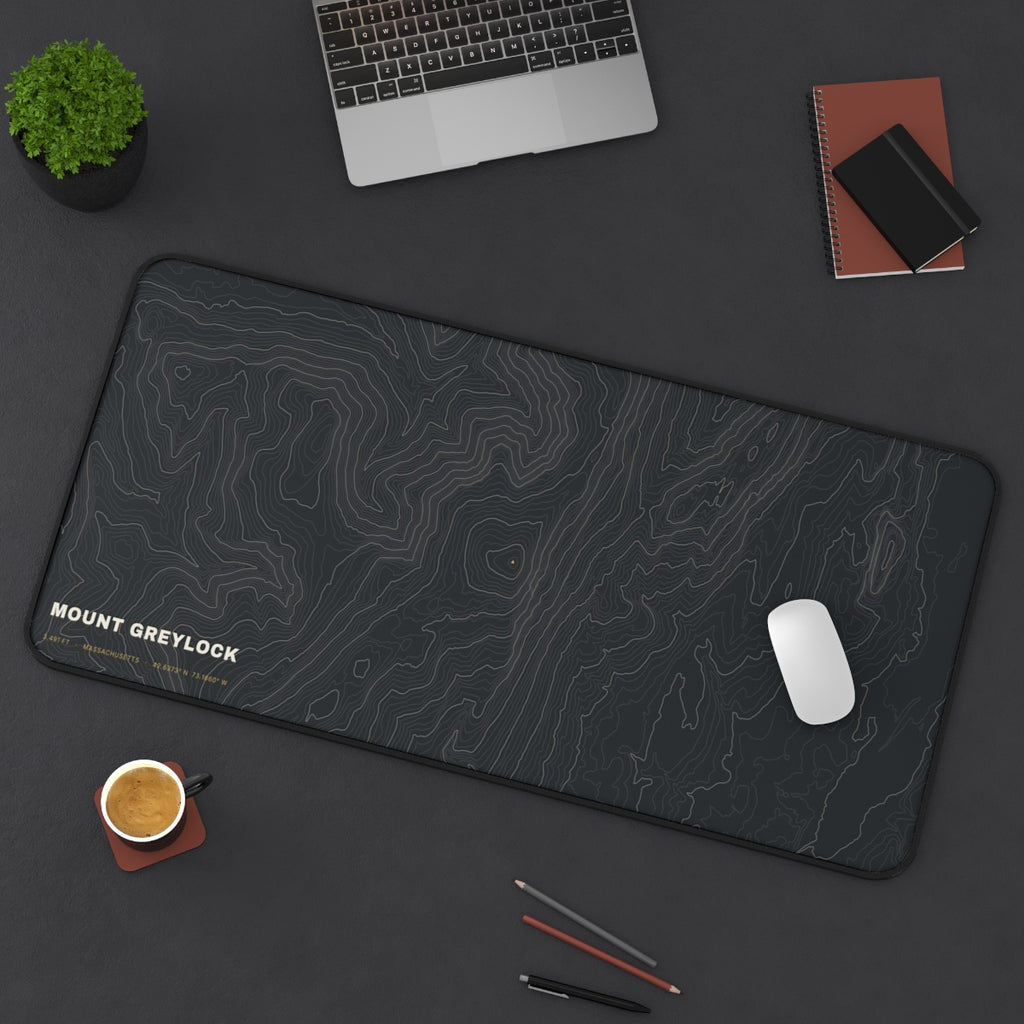 Mount Greylock Topo desk mat on a desk with a laptop, mouse and coffee cup for scale