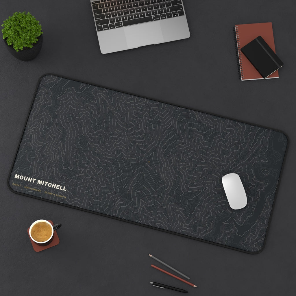 Mount Mitchell Topo desk mat on a desk with a laptop, mouse and coffee cup for scale