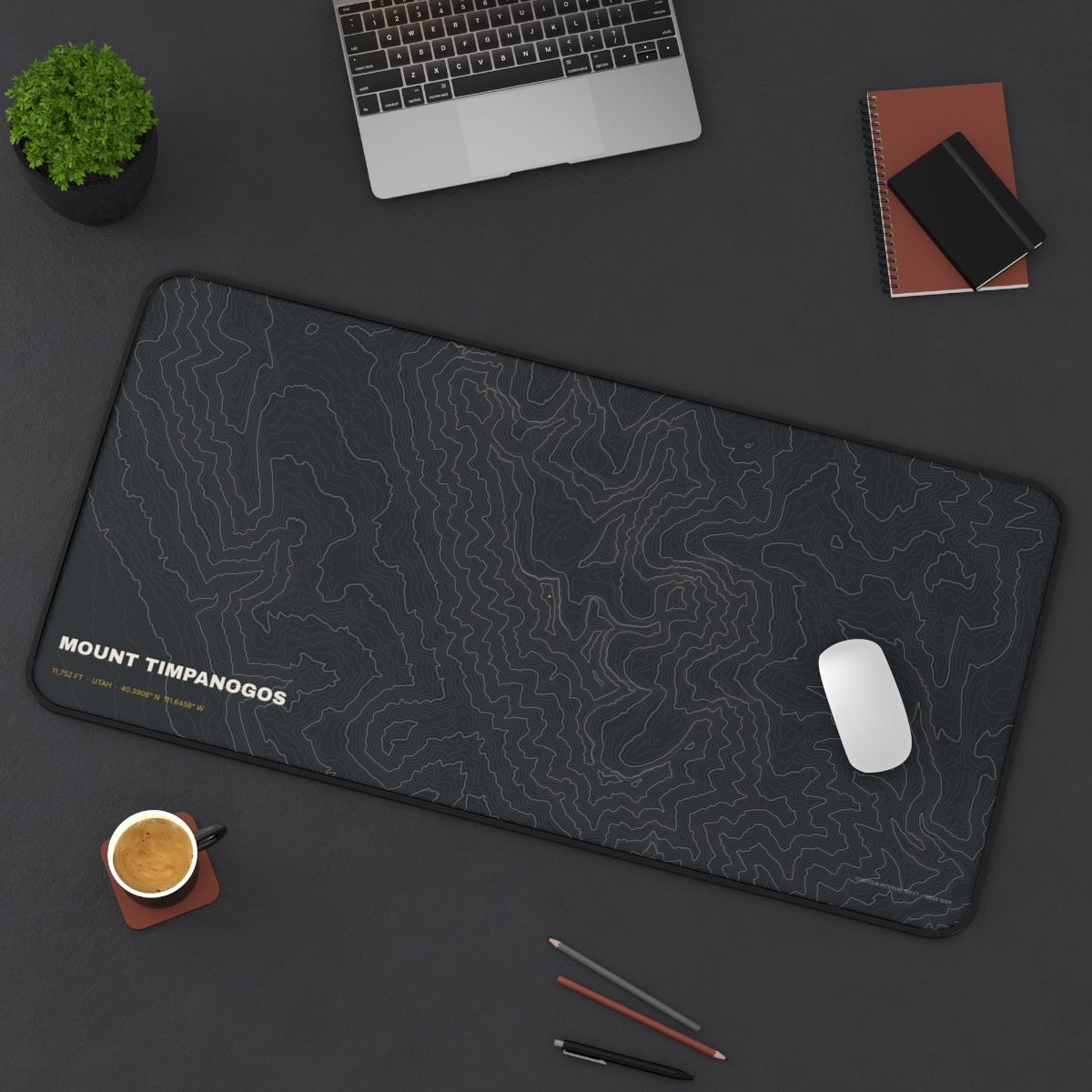 Mount Timpanogos Topo desk mat on a desk with a laptop, mouse and coffee cup for scale