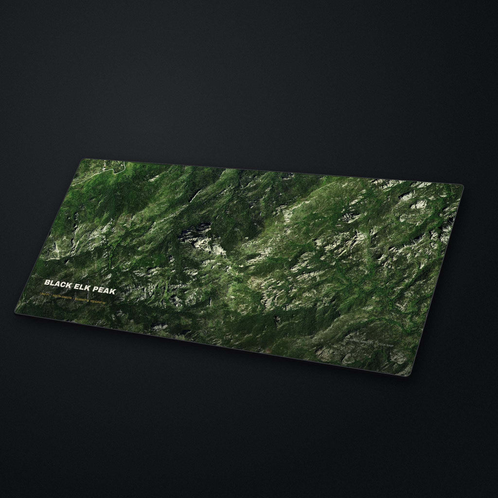 Black Elk Peak Satellite Desk Mat at an angle on a stone desk