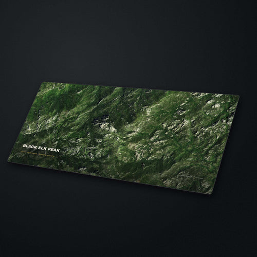 Black Elk Peak Satellite Desk Mat at an angle on a stone desk