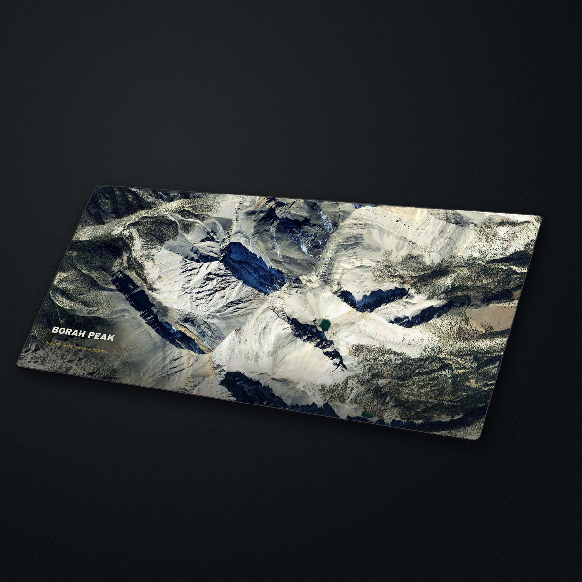 Borah Peak Satellite Desk Mat at an angle on a stone desk