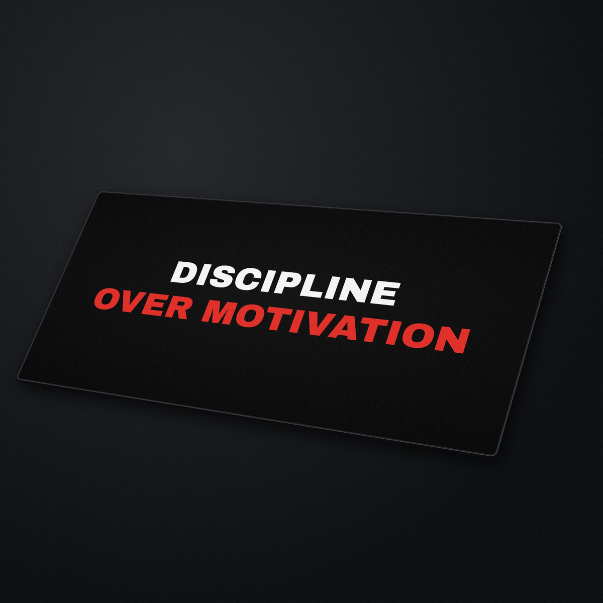 Discipline Over Motivation Desk Mat at an angle on a stone desk