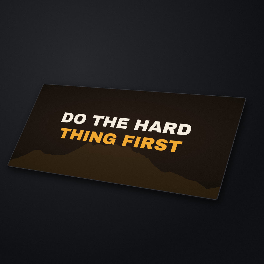 Do the Hard Thing First Desk Mat at an angle on a stone desk