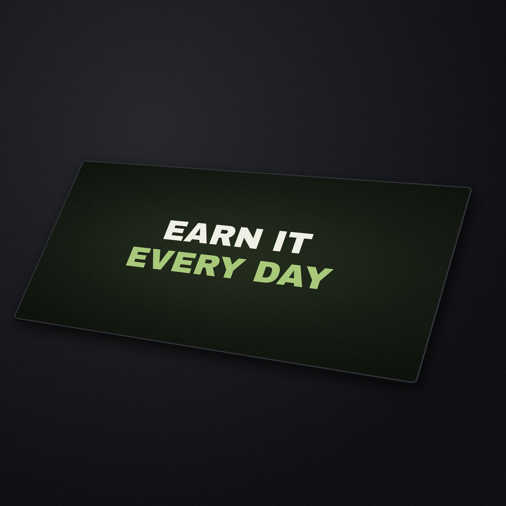 Earn It Every Day Desk Mat at an angle on a stone desk