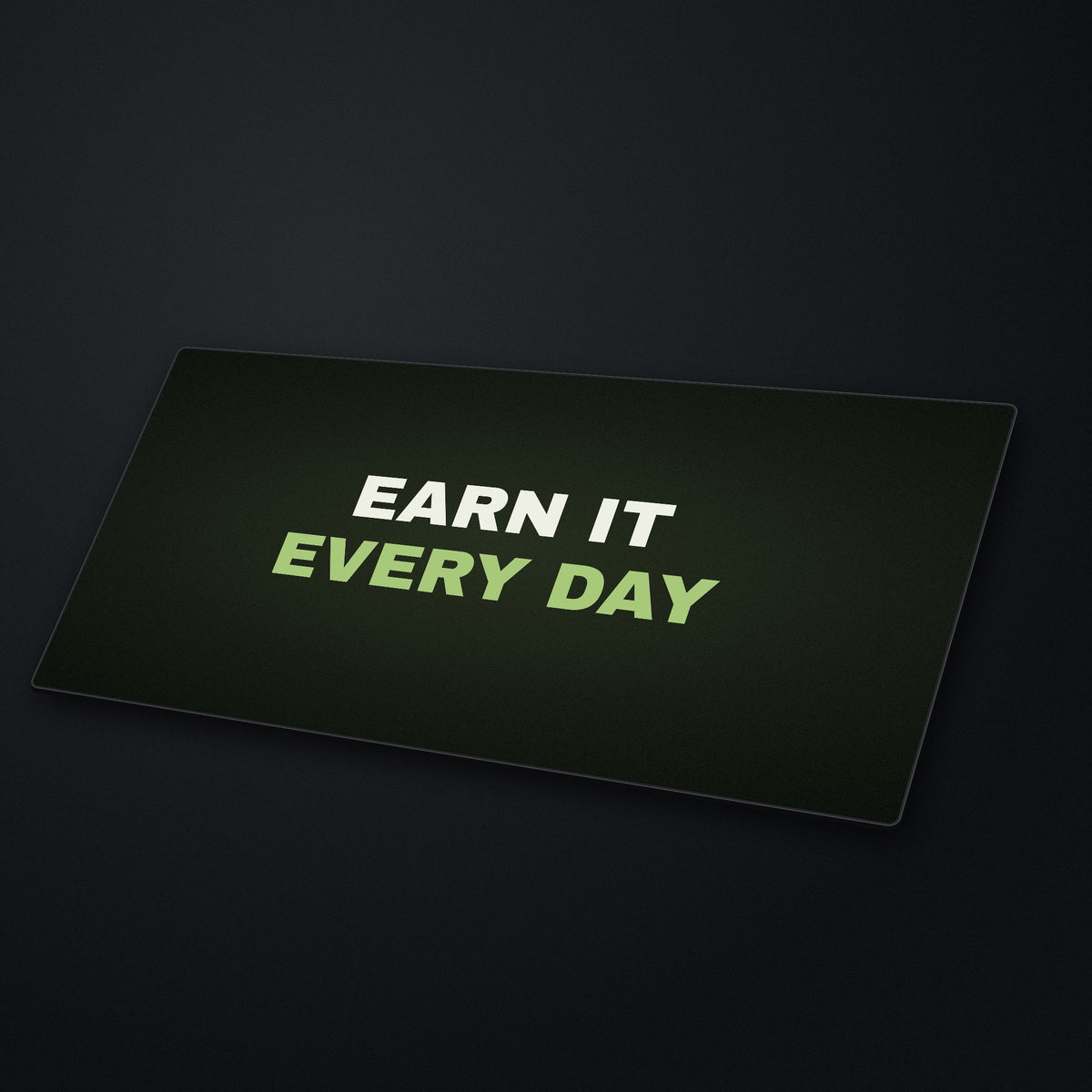 Earn It Every Day Desk Mat at an angle on a stone desk