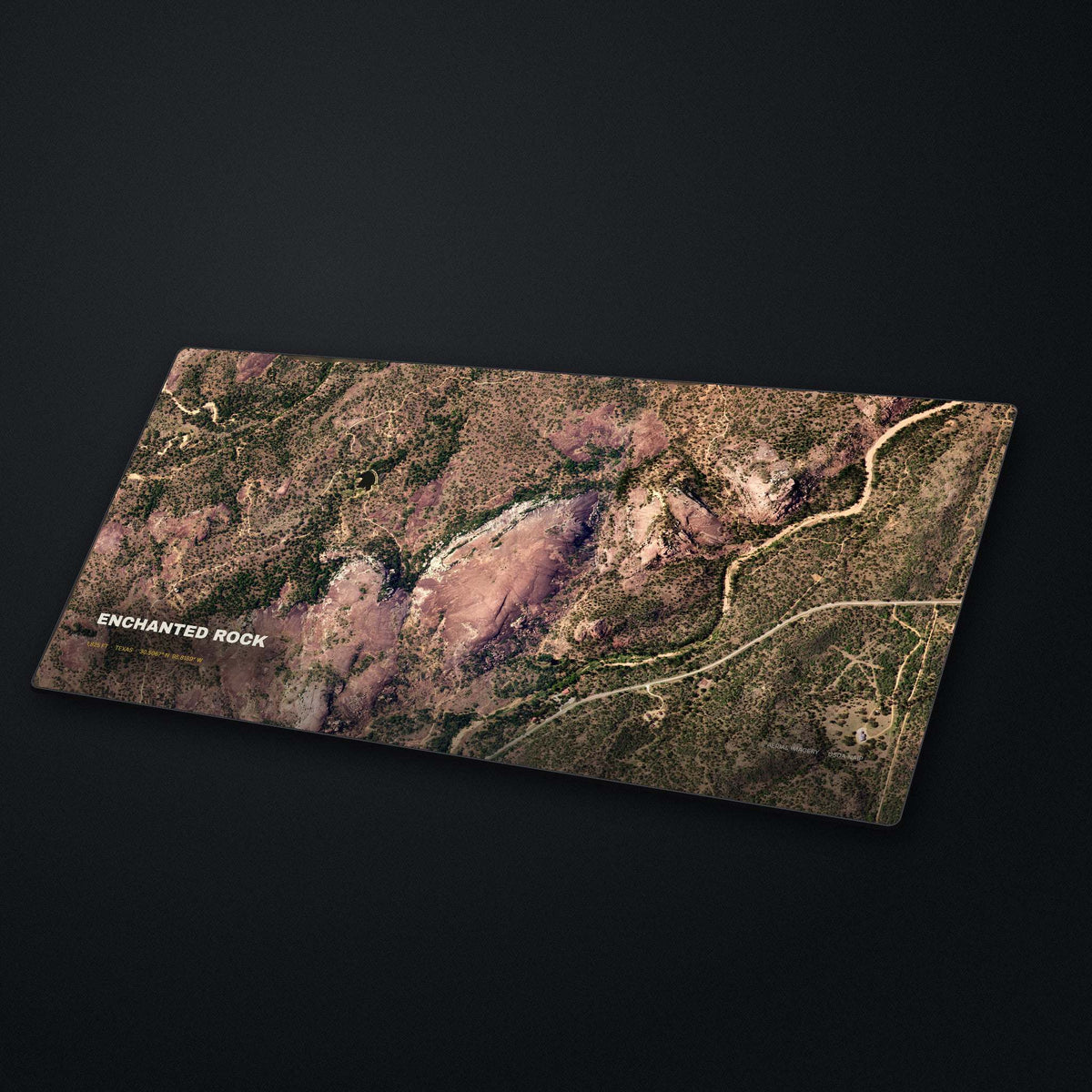 Enchanted Rock Satellite Desk Mat at an angle on a stone desk