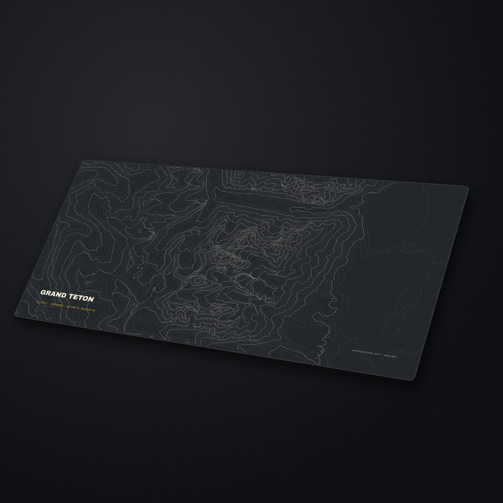 Grand Teton Topo Desk Mat at an angle on a stone desk