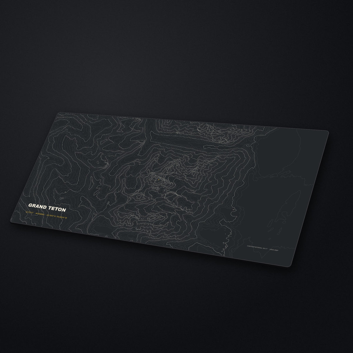 Grand Teton Topo Desk Mat at an angle on a stone desk