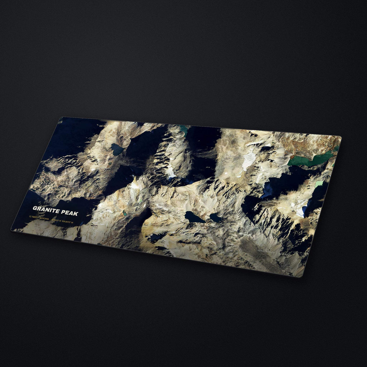 Granite Peak Satellite Desk Mat at an angle on a stone desk