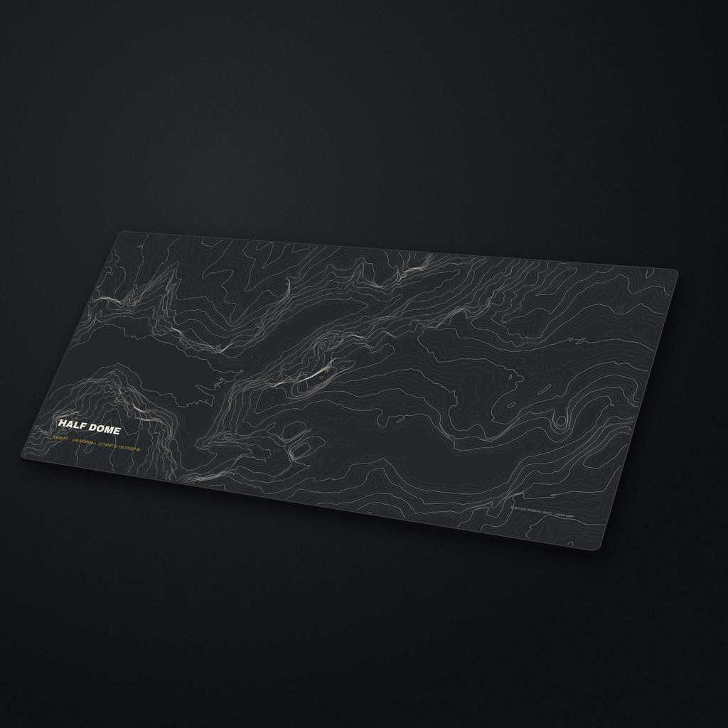 Half Dome Topo Desk Mat at an angle on a stone desk