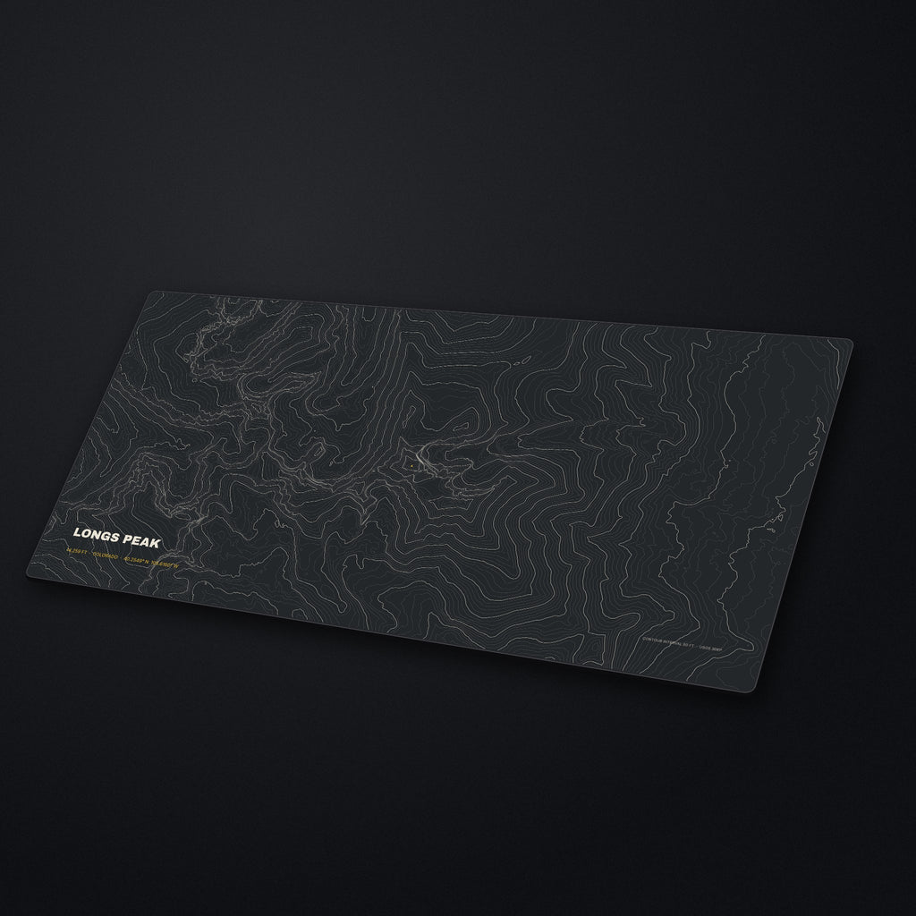 Longs Peak Topo Desk Mat at an angle on a stone desk