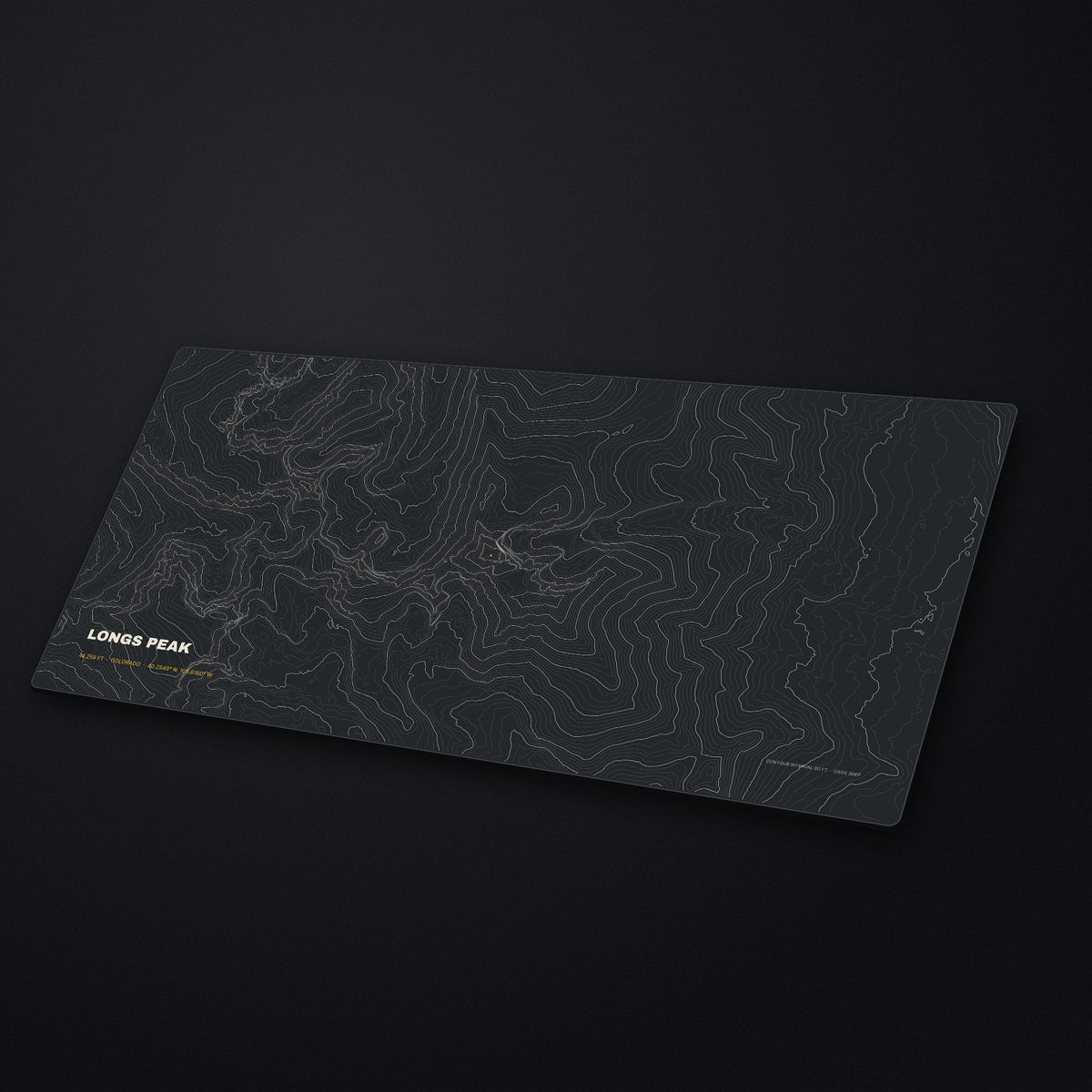 Longs Peak Topo Desk Mat at an angle on a stone desk