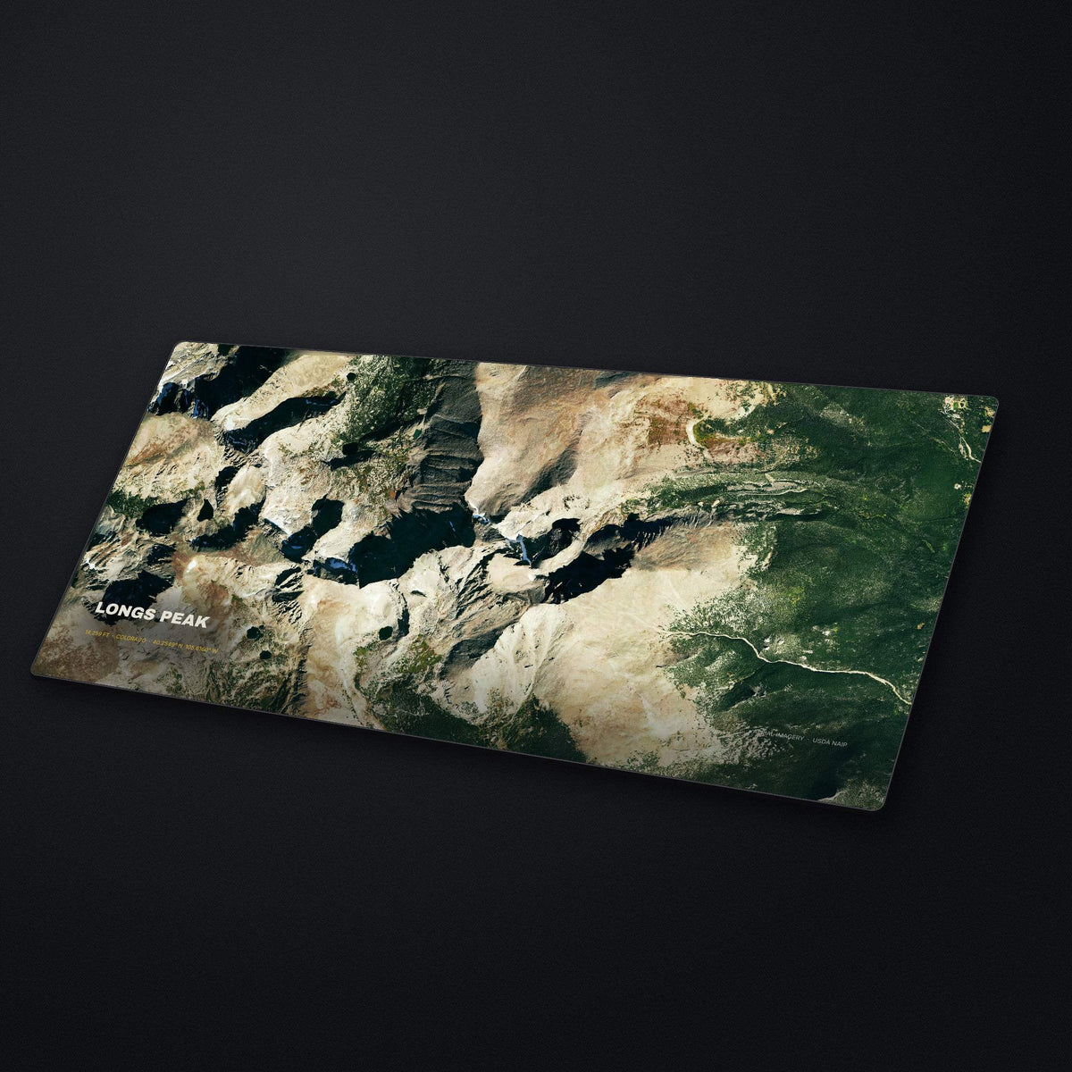 Longs Peak Satellite Desk Mat at an angle on a stone desk